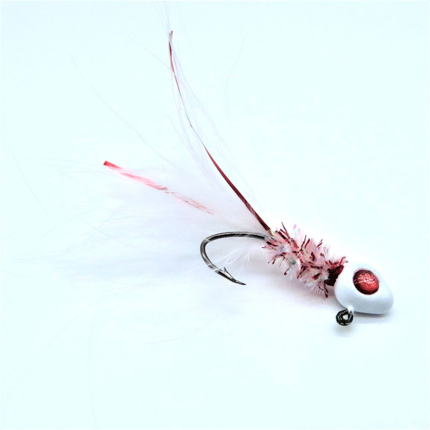 Hand tied Crappie jig featuring a white minnow head, red 3D eyes, white and red bleeding minnow body chenille, white marabou tail, and red flash. Hand tied onto a #4 Mustad sickle hook by Ramble Tamble Tackle.